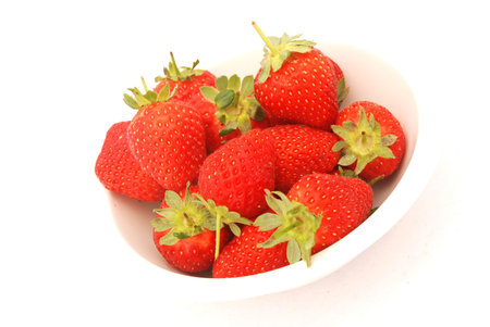 Fresh delicious red strawberries in a bowl isolated on white backgroundの写真素材