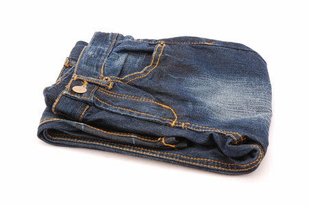 A folded washed out blue denim isolated on white backgroundの写真素材