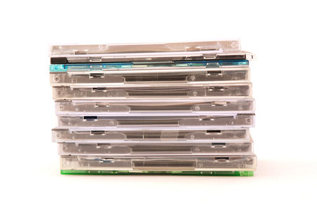A stack of plastic compact disk covers isolated on white backgroundの写真素材