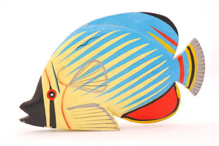 A colorful tropical wooden fish for decoration isolated on white backgroundの写真素材