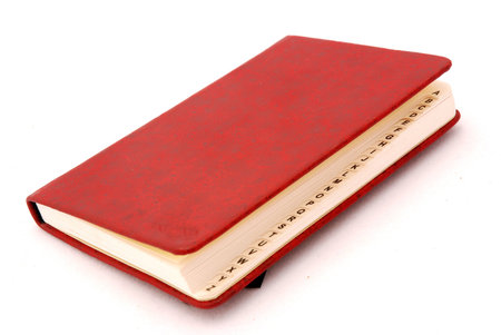 A red directory book with capital letters isolated on white backgroundの写真素材