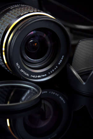 the lens to modern profesionalny camera SLR on the black background の写真素材