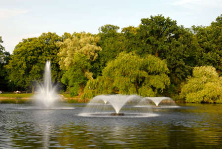 Four fountains on the pond in the parkの写真素材