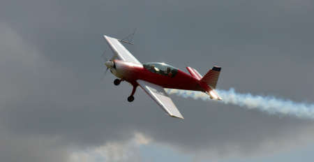 Red acrobatic plane in action.