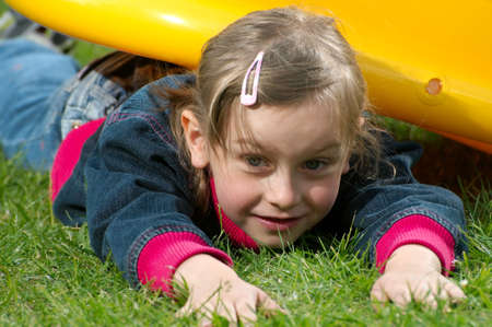 young girl lies on the grassの写真素材