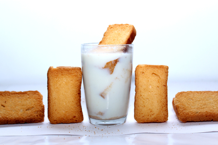 Rusk dip in milk and stackedの写真素材