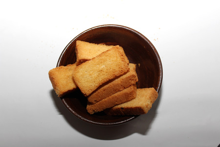 Rusk in a wooden bowl on the white table