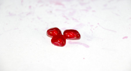 Group of pomegranate seeds isolated on white backgroundの写真素材