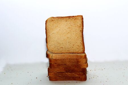 Stack of brown bread isolated on a white backgroundの写真素材