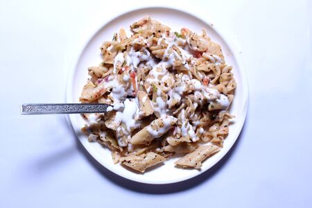 An Italian pasta served in a white plateの写真素材