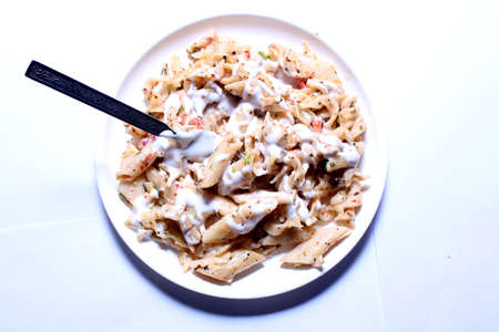 An Italian pasta served in a white plateの写真素材