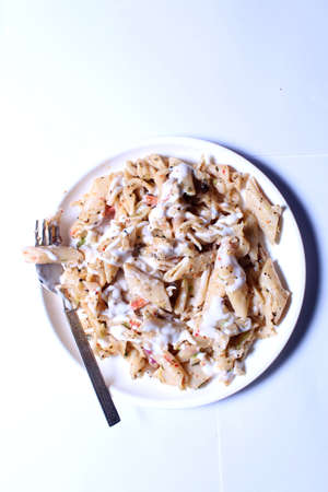 An Italian pasta served in a white plateの写真素材