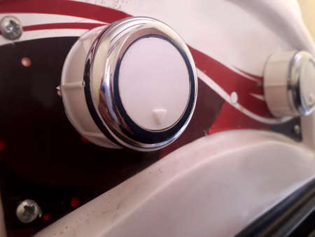 Closeup of air cooler speed control in white color and shiny steel edges.
