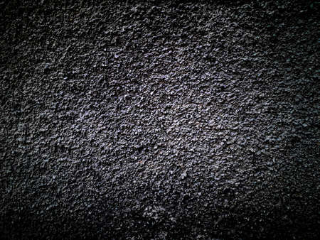 Dark grey grunge or asphalt background empty space for text.