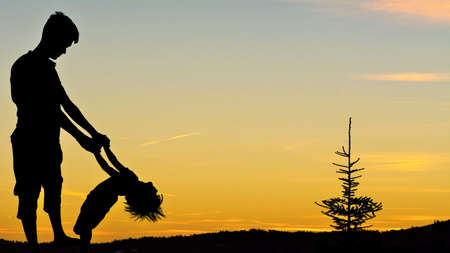Father making fun with little daughter in deserts area / father's day black clipの写真素材