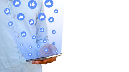 Asian male holding smart phone in hand and swipe screen social media day conceptual.