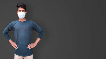 young male model wearing face mask for corona virus isolated photoの写真素材