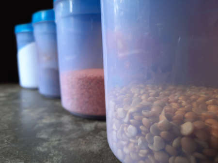 Jars with various spices in a kitchen selective focus