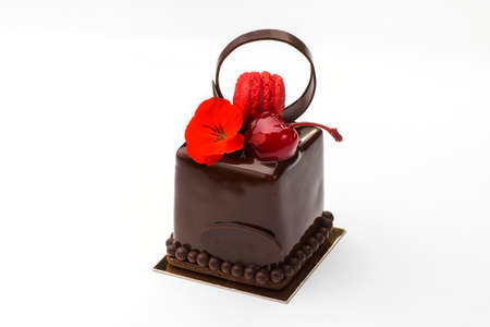 Biscuit cake with macaroons in chocolate with cherry