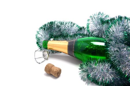 Empty bottle of champagne and Christmas tinsel on white background.の写真素材