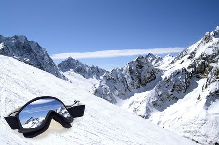Ski goggles with reflection on slope of Caucasus Mountains.の写真素材