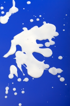 Stains from milk on blue backgroundの写真素材