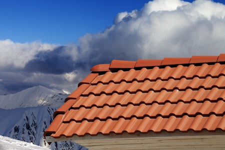Roof tiles against winter mountains