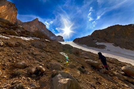 Weary hiker ascent to mountain pass in evening. Turkey, Central Taurus Mountains, Aladaglar (Anti-Taurus). Wide angle view. の写真素材