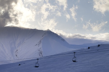 Ski slope and chair-lift in evening. Ski resort Gudauri. Caucasus Mountains, Georgia.の写真素材