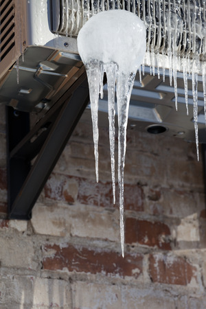 Icicle on icy air conditionerの写真素材