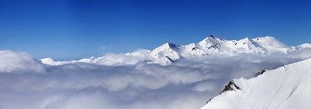 Panorama of mountains under clouds at nice day. 