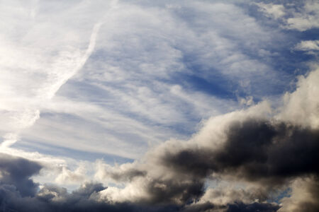 Sunny sky with dark clouds