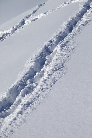 Background of off-piste ski slope with new-fallen snow at nice sun day