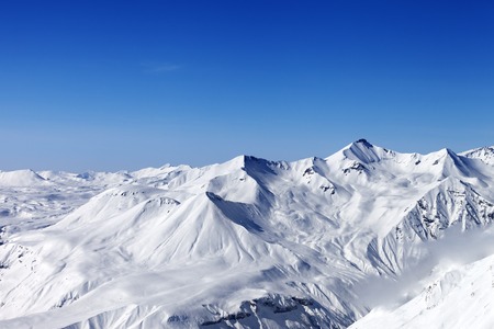 Snow mountains and blue clear sky. Caucasus Mountains, Georgia. View from ski resort Gudauri.の写真素材