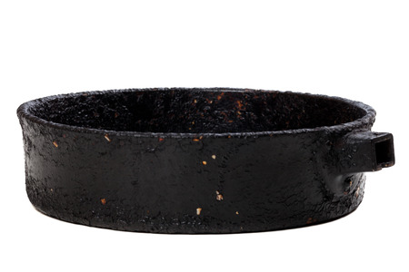 Old frying pan isolated on white background. Selective focus.の写真素材