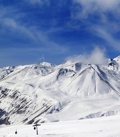 Winter snowy mountains and ski slope at sun day. Caucasus Mountains, Georgia. Ski resort, Gudauri.の写真素材