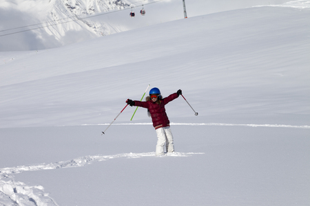 Happy girl on off-piste slope with new fallen snow at nice sun day. Caucasus Mountains, Georgia, region Gudauri.の写真素材