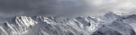 Panoramic view on high sunlight mountains and storm sky before blizzard. Caucasus Mountains. Svaneti...