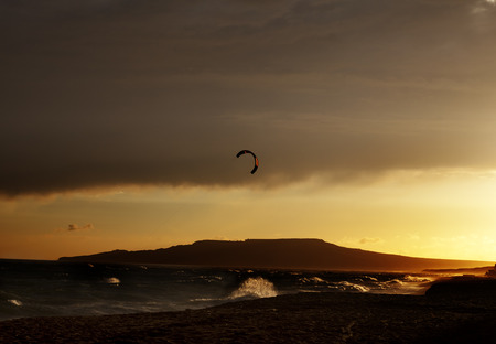 Silhouette of power kites at beautiful sunset skyの写真素材
