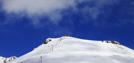 Panoramic view on ropeway and ski slope in sun day. Caucasus Mountains, Georgia, region Gudauri.の写真素材