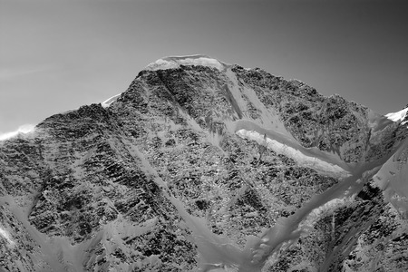 Black and white view on mountains with snow in winter sun evening. Mount Donguzoruns. Caucasus...