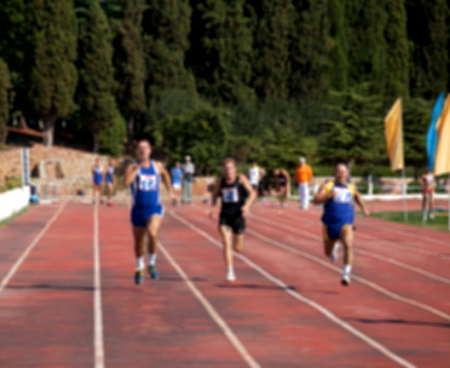 Blurred view of man athletic running competition at stadium not in focus. Use as background.のeditorial素材