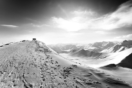 Black and white view on top station of ropeway in sun winter evening. Caucasus Mountains, Georgia, region Gudauri. Wide-angle view.の写真素材