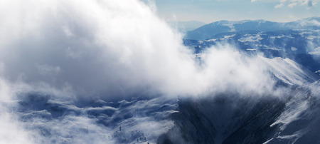 Panoramic view on winter snowy mountains in sunlight clouds at nice sun evening. Caucasus Mountains, Georgia, region Gudauri.の写真素材
