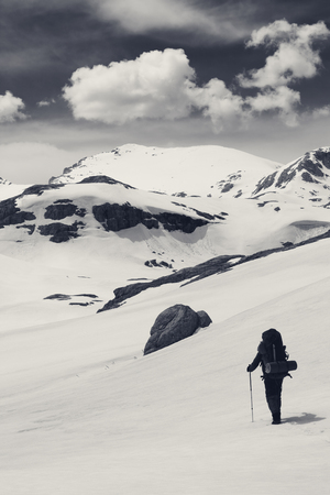Hiker in snowy mountains. Turkey, Central Taurus Mountains, Aladaglar (Anti-Taurus), plateau Edigel (Yedi Goller). Black and white toned landscape.の写真素材