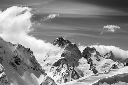 Winter mountains with snow cornice and sky with cloudsの写真素材