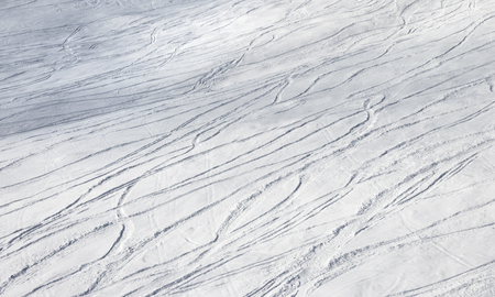 Snowy ski slope for freeride with trace from skis and snowboards at sun winter dayの写真素材
