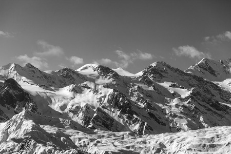 View on snowy mountains and glacier in nice sunny evening. Caucasus Mountains at winter. Svaneti region of Georgia. Black and white toned landscape.の写真素材