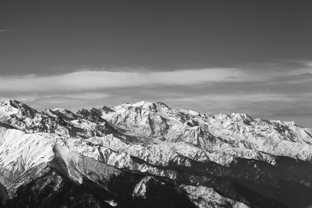 Black and white snowy mountains in nice sunny evening. Caucasus Mountains at winter. Svaneti region of Georgia.の写真素材