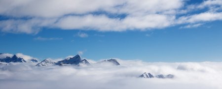 Panoramic view on snowy sunlight mountains in fog at nice sun day. Caucasus Mountains in winter, Georgia, region Gudauri.の写真素材
